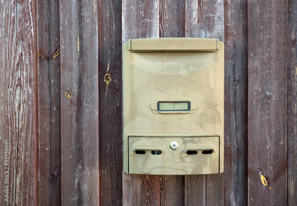 mailbox on a wooden fence