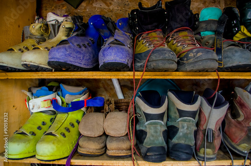 climbing boots in an outdoor shoe shelf