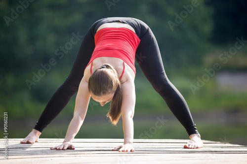 Teenage girl doing Wide Legged Forward Bend
