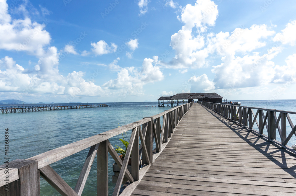 Wooden jetty with blue skies