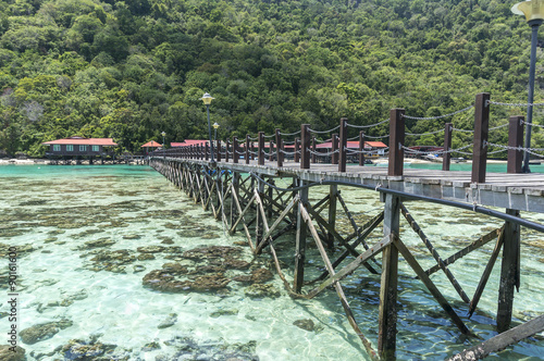 Wooden jetty and corals at a Boghey Dulang island, Sabah, Malaysia.