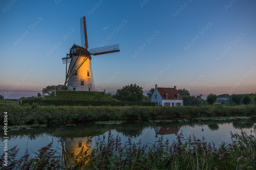Sunrise over windmill in Damme, Belgium