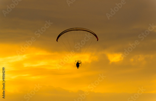 silhouette of paramotor with sunset sky