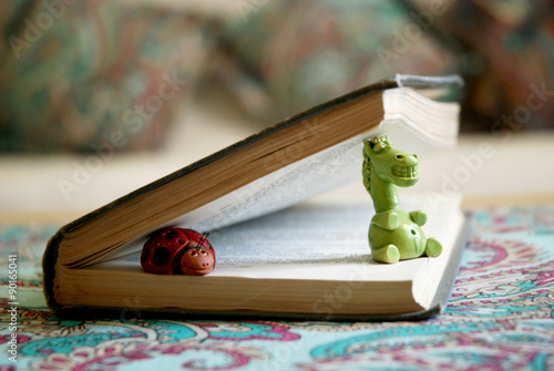 Картината върху платно Ceramic figurines in the book, as if the characters come to life