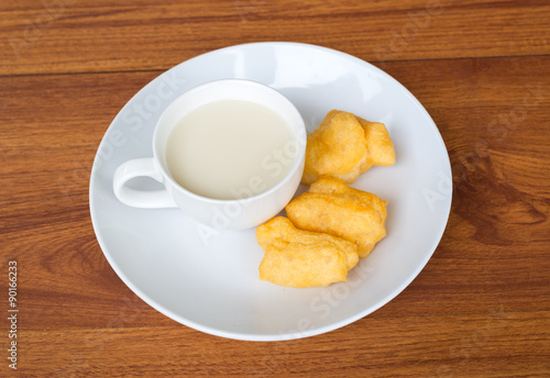 Soy milk and deep-fried dough stick on wood table