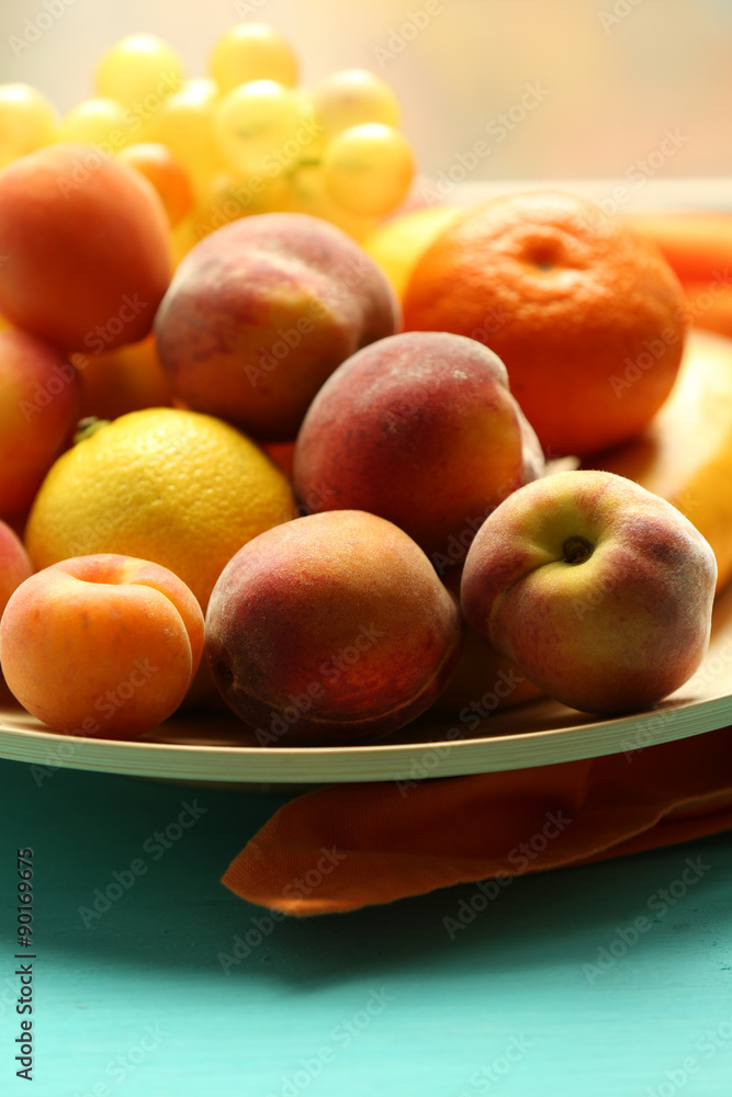 Heap of fresh fruits on tray on wooden table close up Heap of fresh fruits on tray on wooden table close up