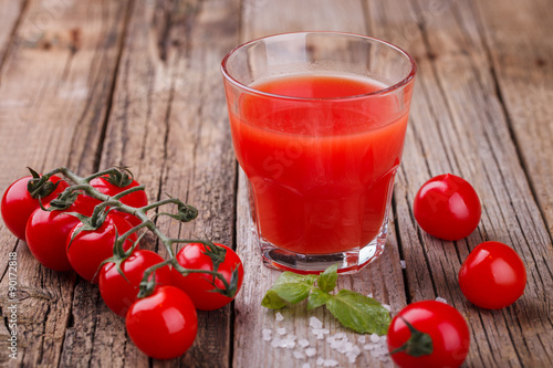 Tomato juice in a glass beaker. Vine tomatoes and Basil.selective focus