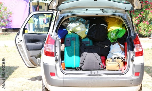 luggage and suitcases in car for departure for summer holidays