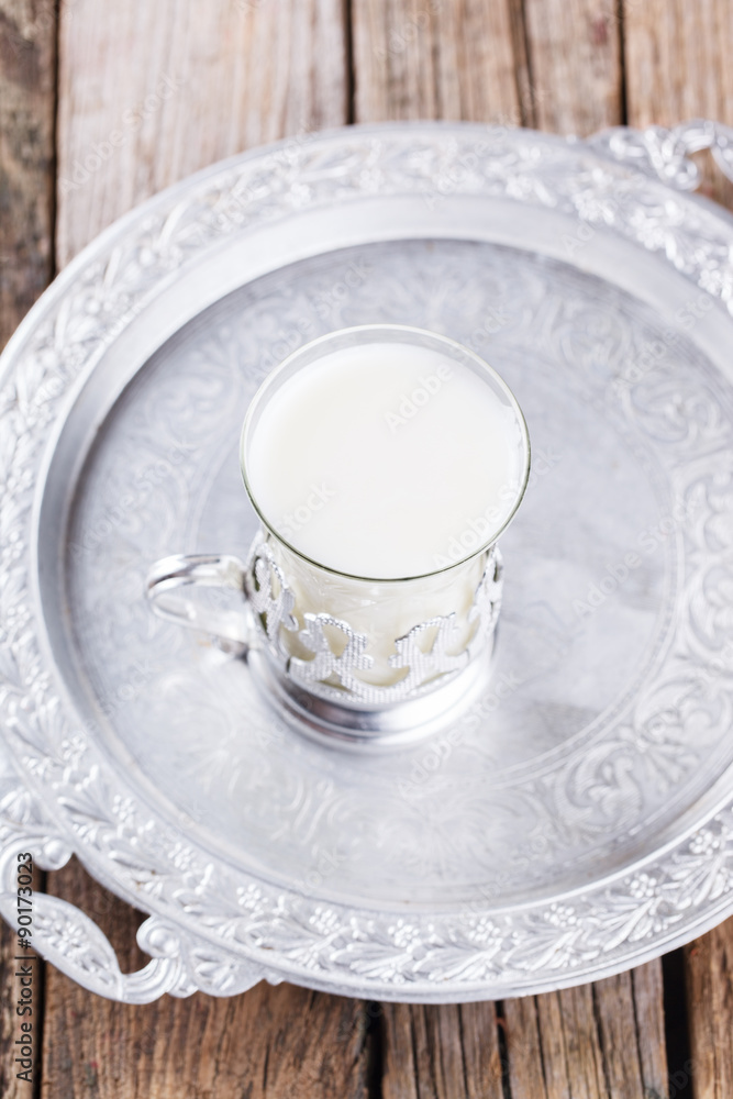 A glass of buttermilk on the tray.Milk product. selective focus A glass of buttermilk on the tray.Milk product. selective focus