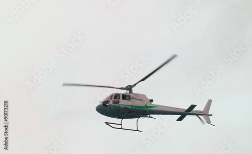 Fototapeta Naklejka Na Ścianę i Meble -  civil helicopter flies in the sky and carries tourists
