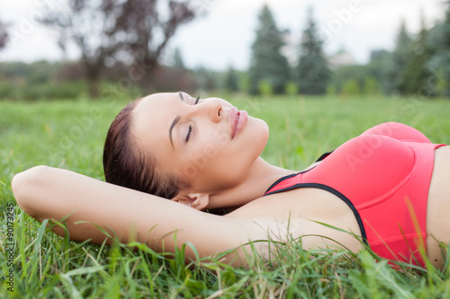 Attractive young girl is relaxing after training