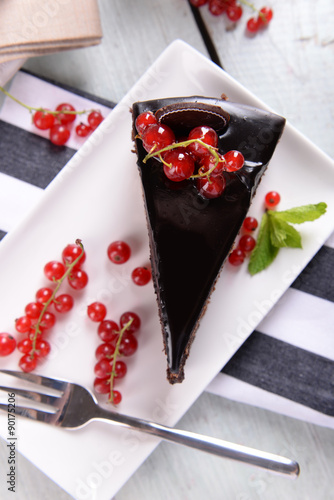 Fototapeta Naklejka Na Ścianę i Meble -  Tasty chocolate cake with berries on table close up