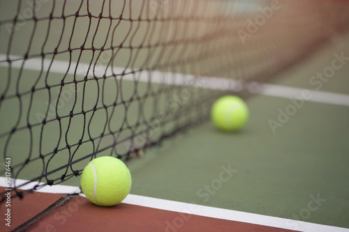 Tennis ball in net at tennis court © tatomm