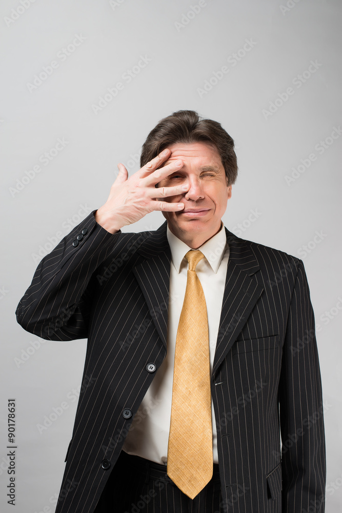 Portrait of man closed one eye with his hand Portrait of man closed one eye with his hand
