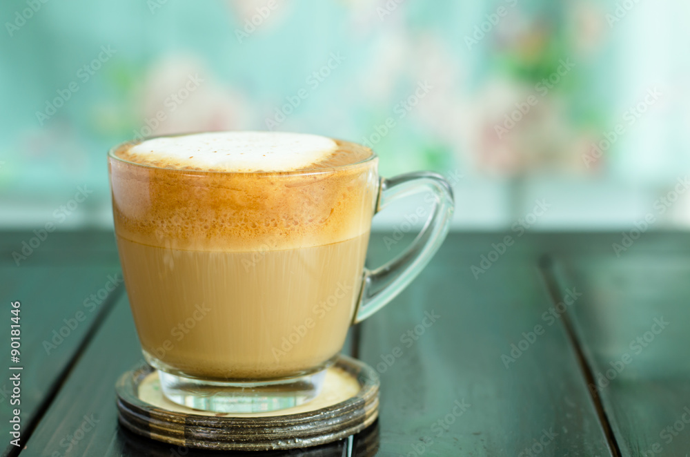 Hot coffee (cappuccino) on the table in the morning Hot coffee (cappuccino) on the table in the morning