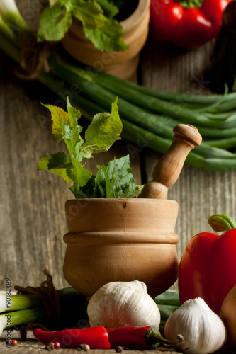 Vintage mortar and mix of vegetables with reflex