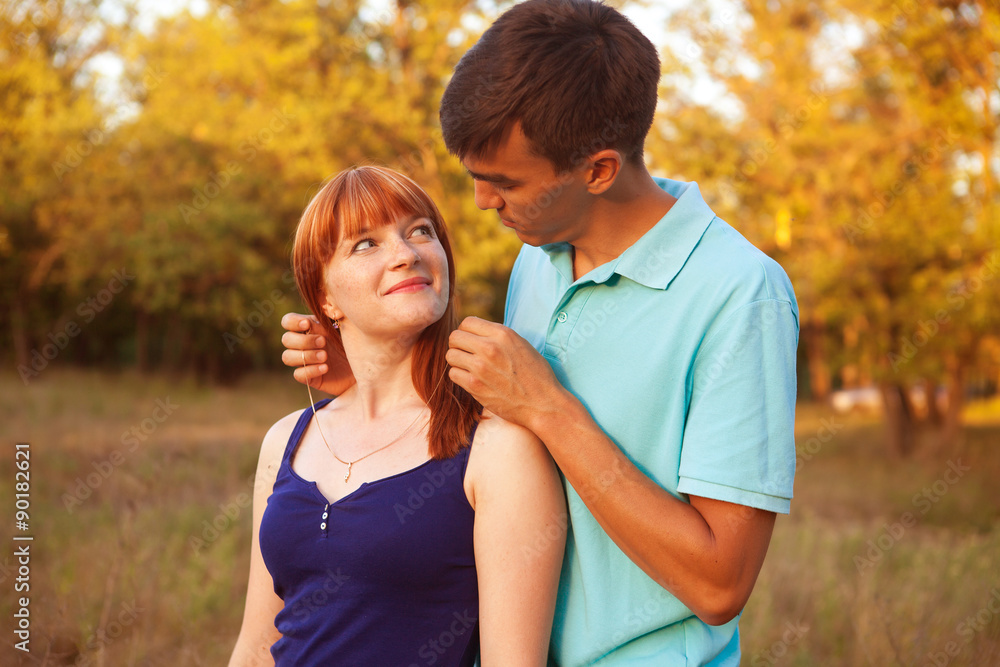 guy wears a chain girl in the park outdoors guy wears a chain girl in the park outdoors