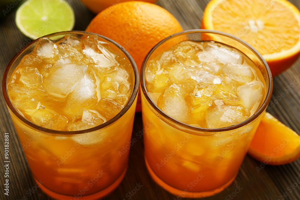 Glasses of orange juice on wooden table, closeup Glasses of orange juice on wooden table, closeup