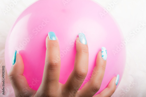 painted nails and pink balloon