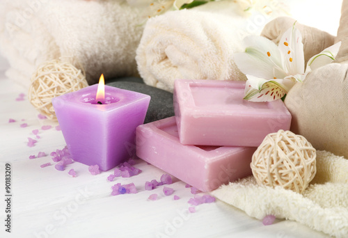Massage bags with spa treatment and flowers on wooden table background