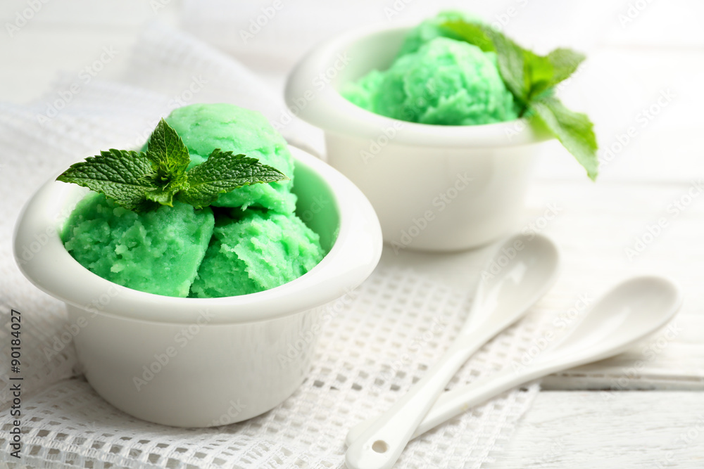 Homemade mint ice-cream on light wooden background Homemade mint ice-cream on light wooden background