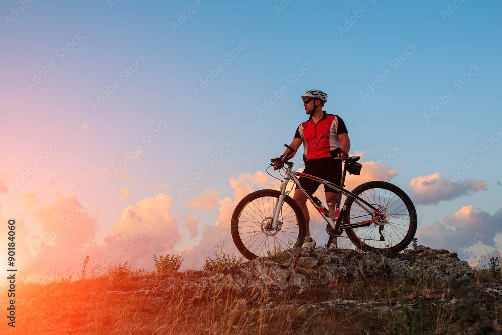 Biker riding on bicycle in mountains Biker riding on bicycle in mountains