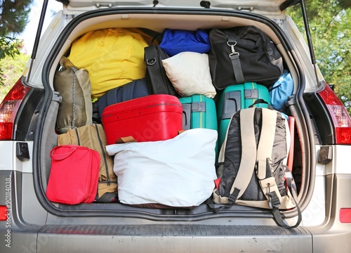 Fotografie car overloaded with suitcases and duffle bag for family travel