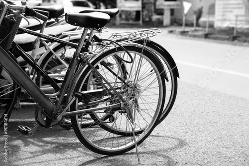 Vintage bicycle on urban roadside. black and white effect