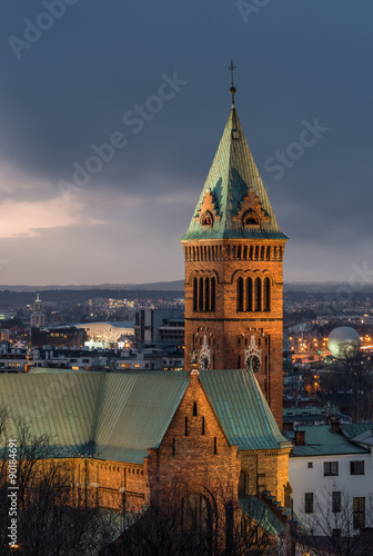 Krakow, Poland, Romanesque revival Church of Our Lady of Perpetual Help in the evening, with a delicate artificial and natural light in the short break between downpours #90184691