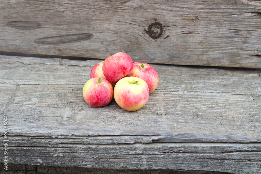 Small group of fresh natural apples on wooden texture Small group of fresh natural apples on wooden texture