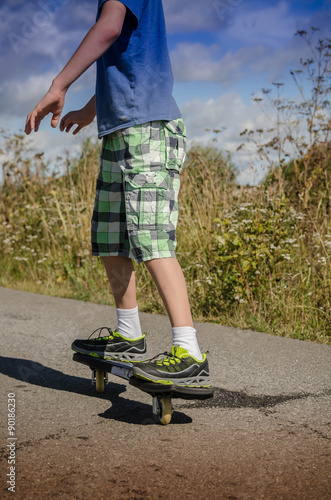 Legs in sneakers on a skateboard photo