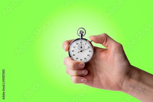 timer hold in hand, button pressed, green background
