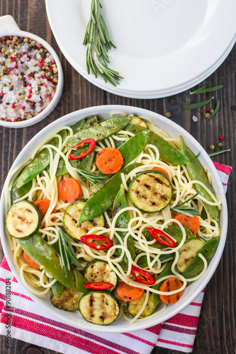 Spaghetti and grilled vegetables - zucchini, carrots, pea pods a