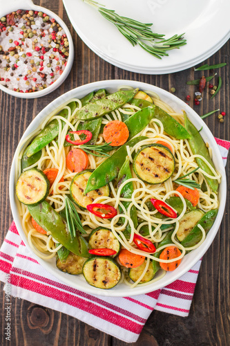 Spaghetti and grilled vegetables - zucchini, carrots, pea pods a