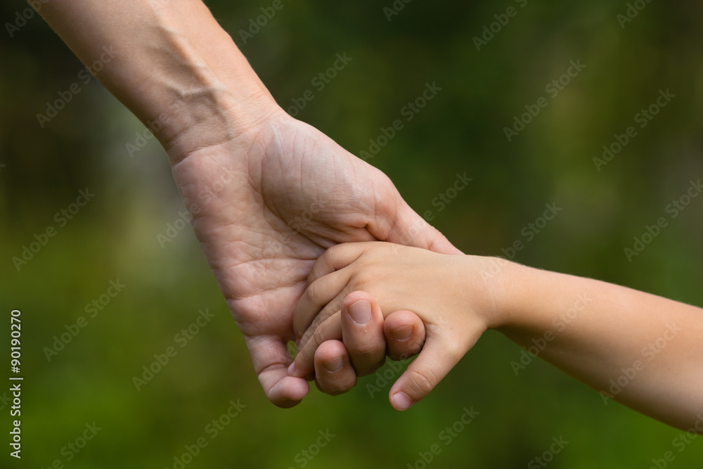 mother holding a child's hand mother holding a child's hand