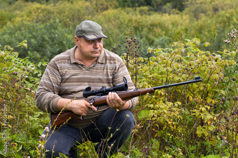 Fototapeta premium sitting hunter with a rifle