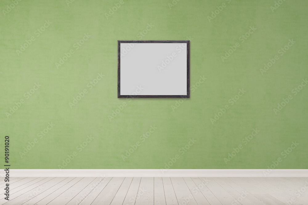 Einzelner Rahmen an grüner Wand Einzelner Rahmen an grüner Wand