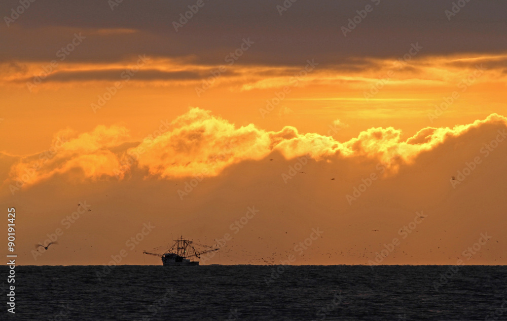 Shrimp Boat in Ocean at Sunrise