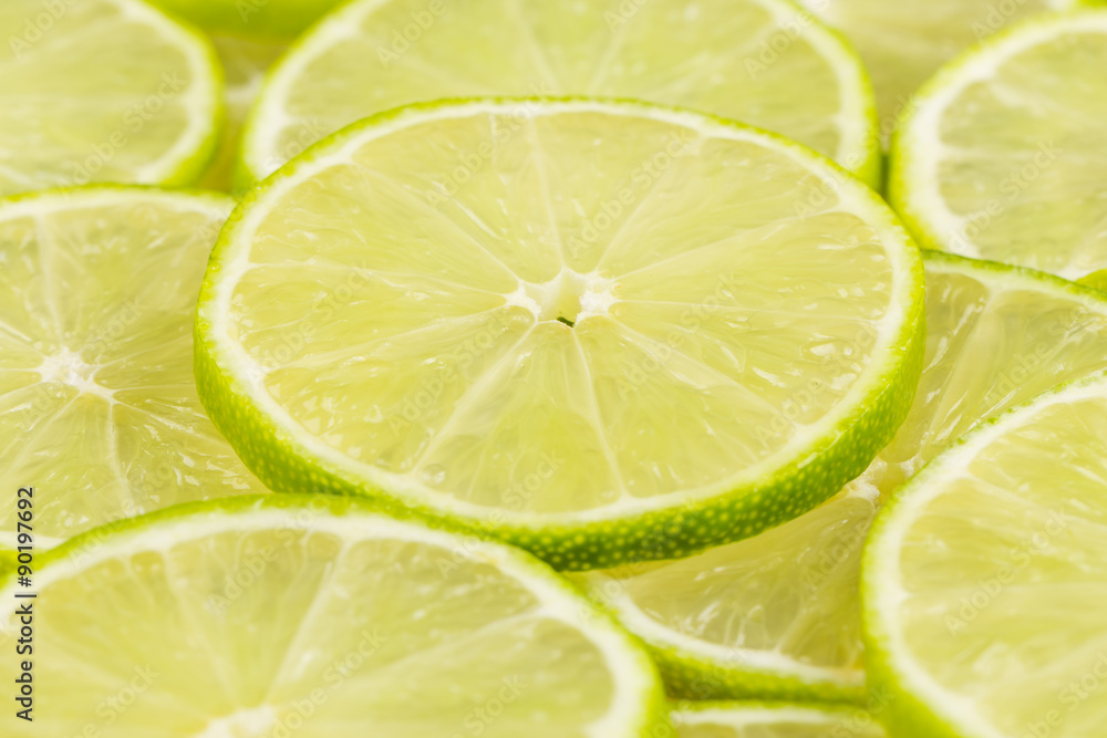 Green background with citrus-fruit of lime slices Green background with citrus-fruit of lime slices