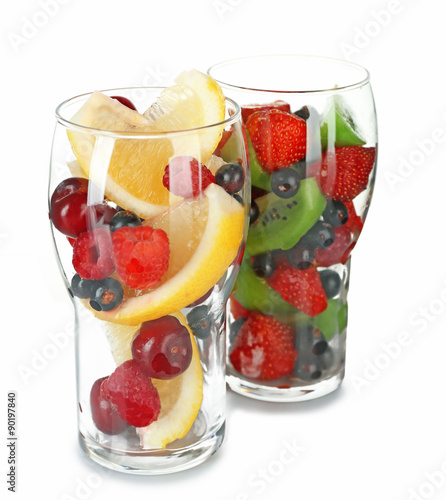 Glasses of berries and fruits isolated on white