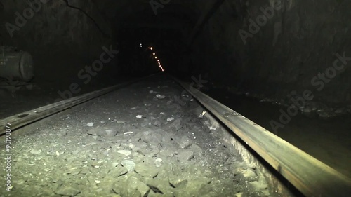 Mining of iron ore in the mine. Mining, loading into trucks and transportation of iron ore in the mine electric locomotive.