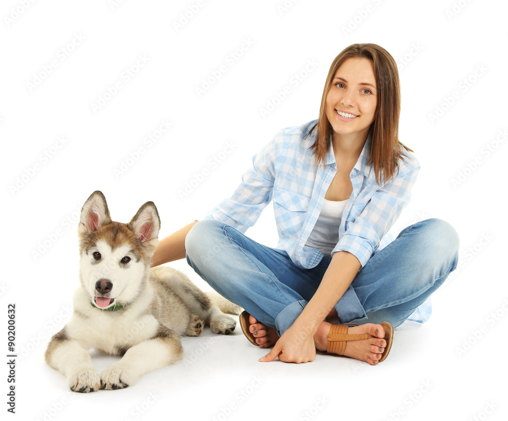 Young woman with malamute puppy isolated on white Young woman with malamute puppy isolated on white