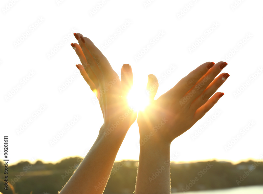 Female hands on sunny sky background Female hands on sunny sky background