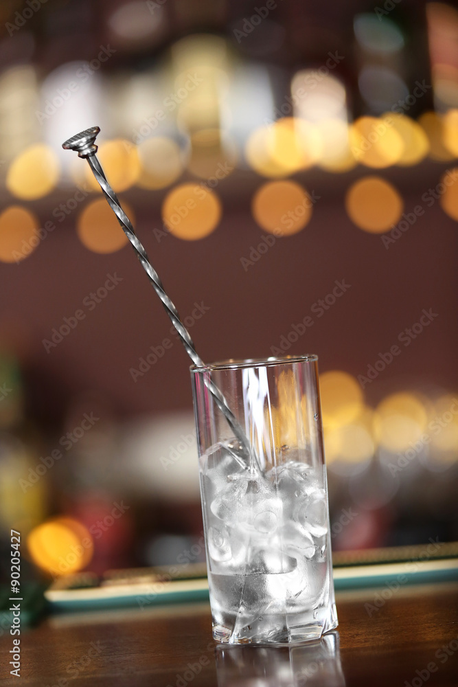 Glass with ice on bar counter Glass with ice on bar counter
