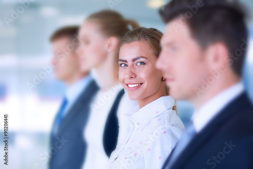 Smiling successful business team standing in office