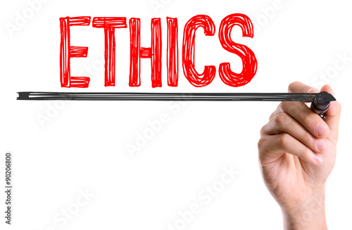 Hand with marker writing the word Ethics