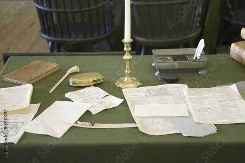 Restored Assembly Room displaying 18th century papers in Independence Hall, Philadelphia, Pennsylvania, one of the meeting places of the Second Continental Congress, where the Declaration of Independence and the Constitution were also debated, adopted, and signed. Future Presidents Washington, John Adams, Jefferson, Madison, and Monroe helped found the Nation in this room. photo
