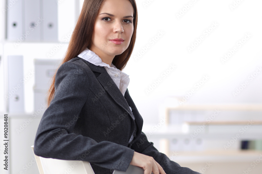 Attractive businesswoman sitting in the office Attractive businesswoman sitting in the office