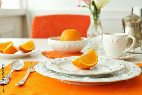 Table setting with orange napkin