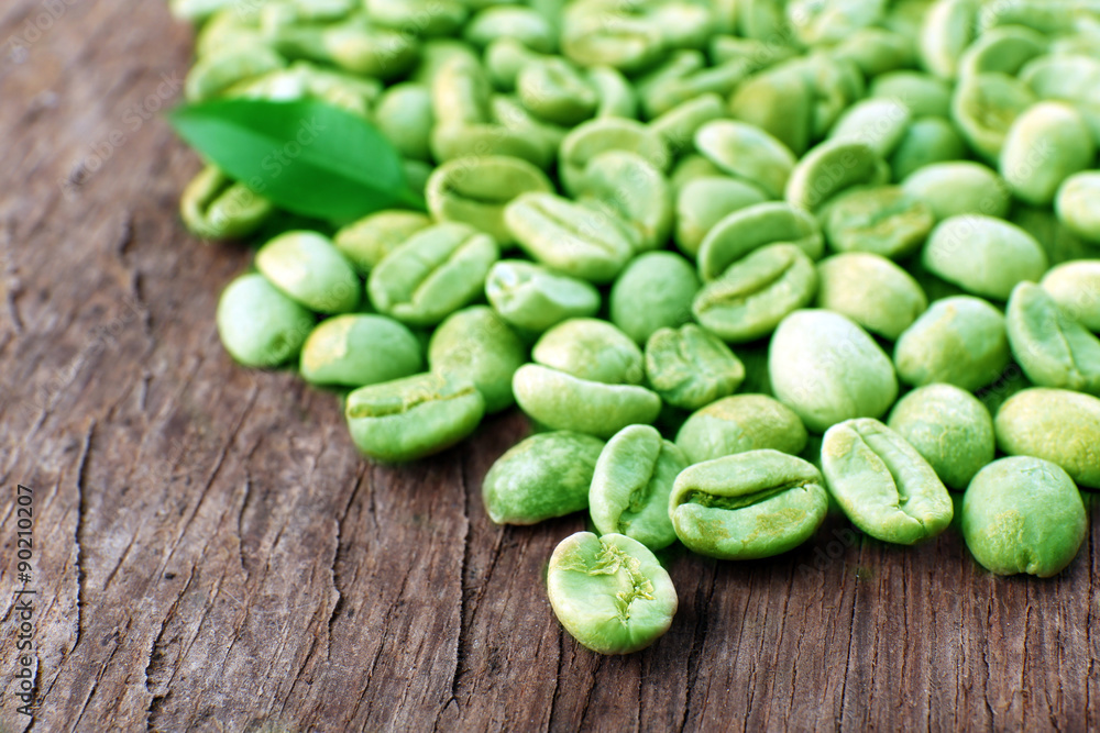 Heap of green coffee beans on table close up Heap of green coffee beans on table close up